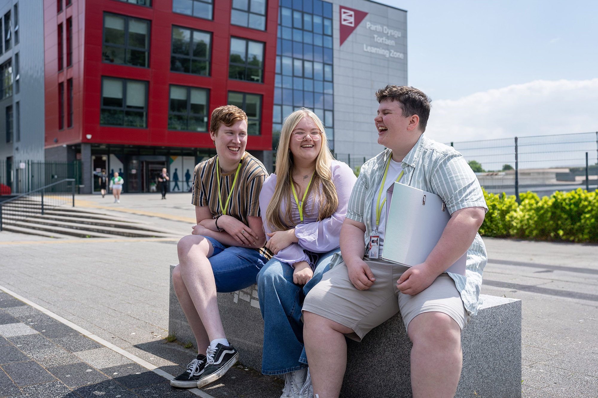 Three students chatting outside Torfaen Learning Zone