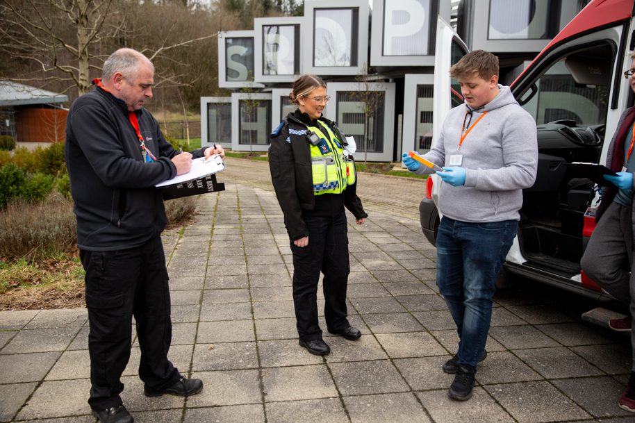 Students talking to tutor and police